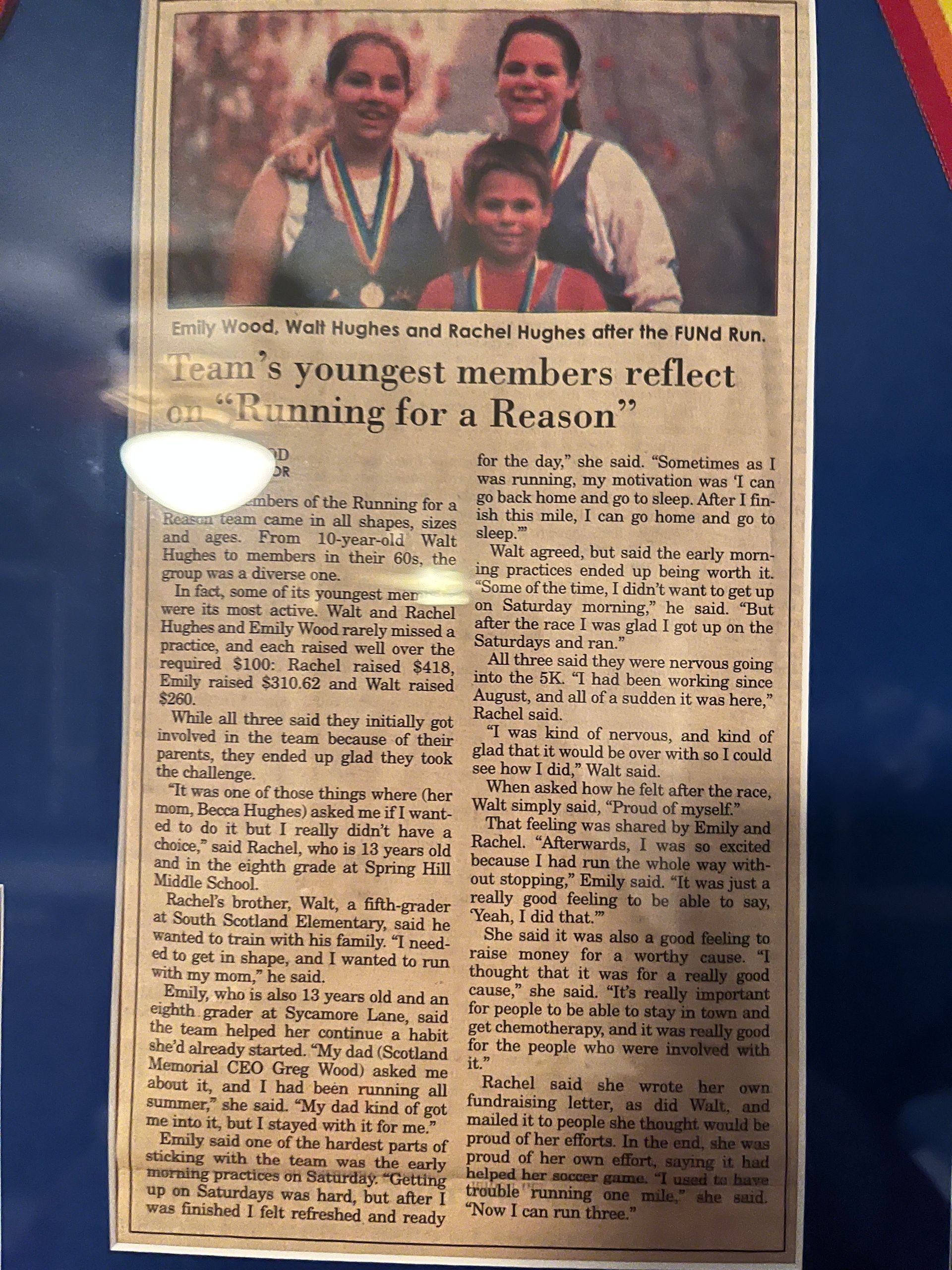 Newspaper clipping featuring three girls with medals, text titled 