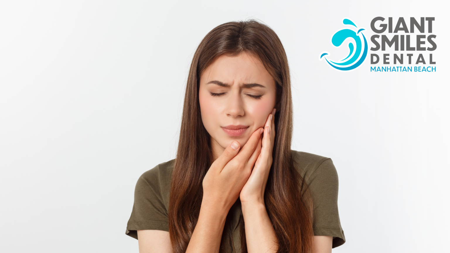 A woman is holding her face in pain because of a toothache.