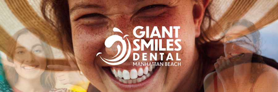 A dentist is holding a model of a person 's teeth with tweezers.