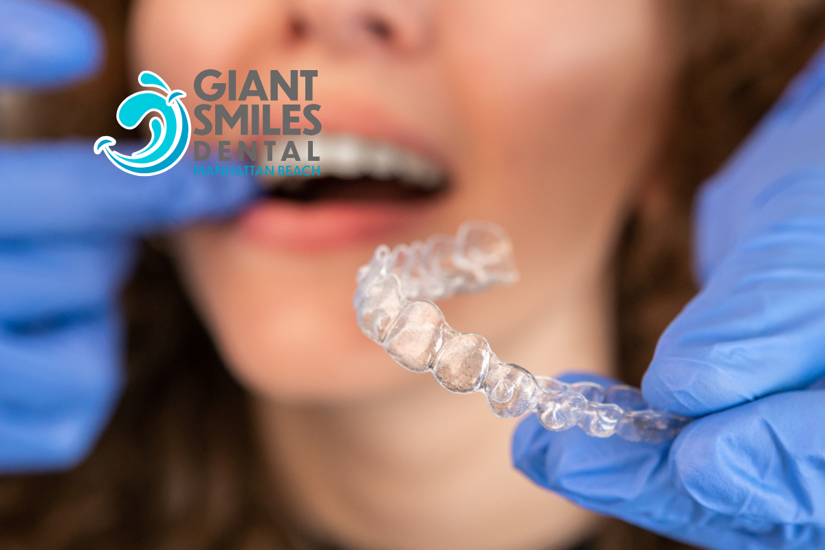 A blurry picture of a dental office with the logo for giant smiles dental manhattan beach.