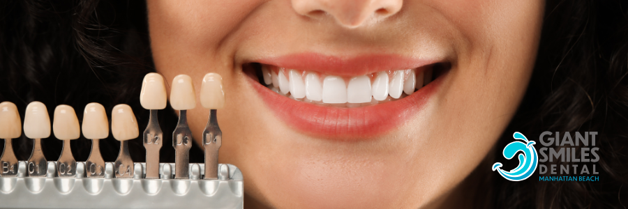 A dentist is holding a model of a person 's teeth with tweezers.