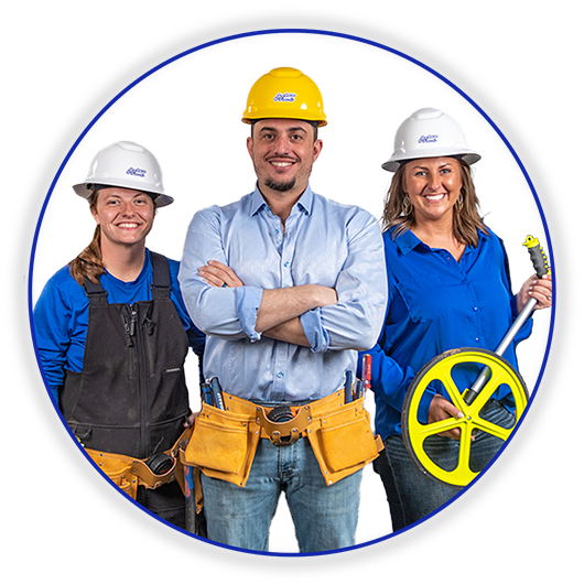 Three construction workers in hard hats holding tools, smiling on a white background