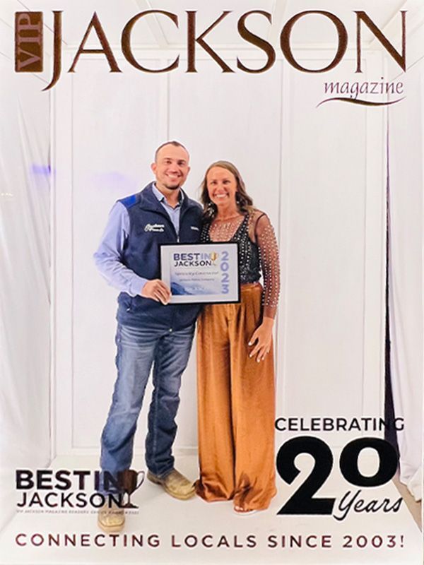 Two people holding a “Best of Jackson” sign at Jackson magazine’s 20th anniversary event