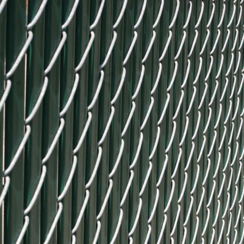 Close-up of a green chain-link fence with white metal wire pattern.