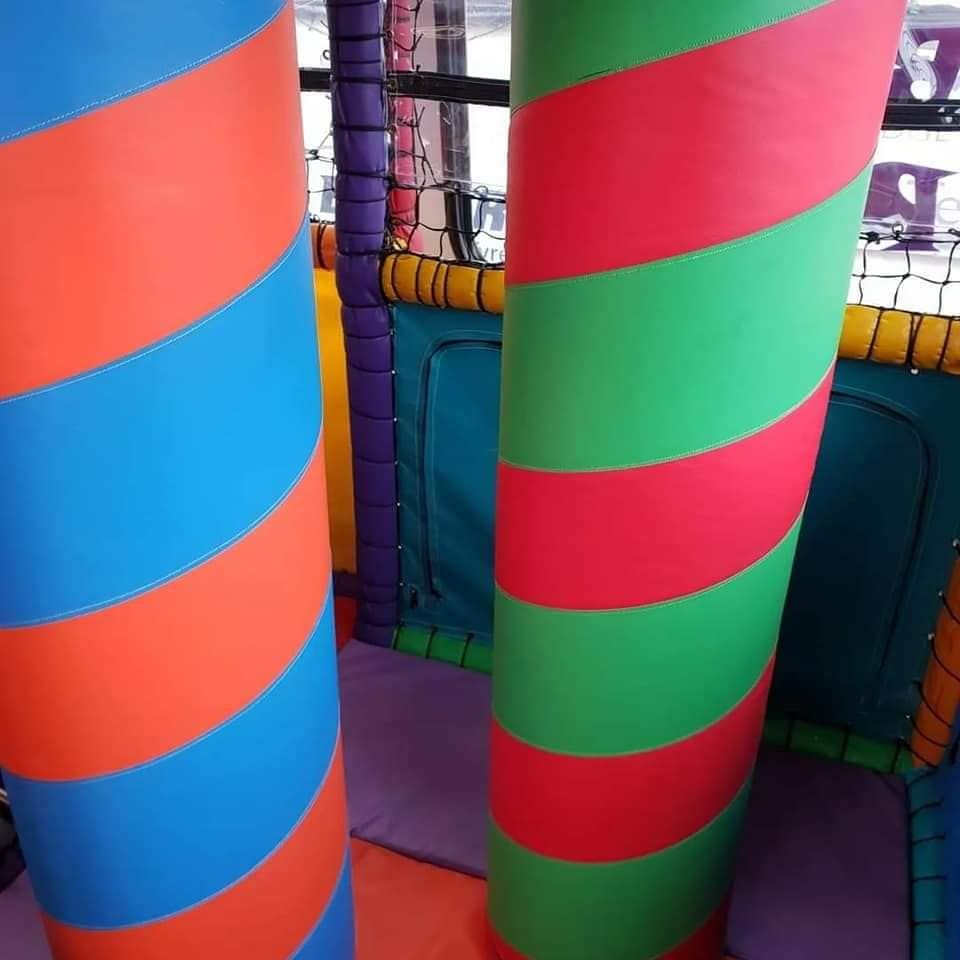 A bunch of colorful striped pillars in a play area