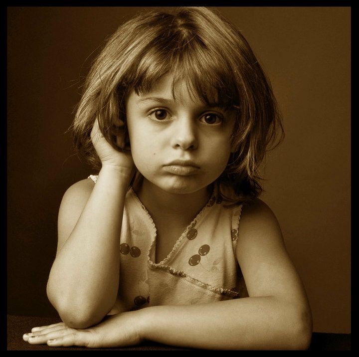 A little girl with a sad look on her face