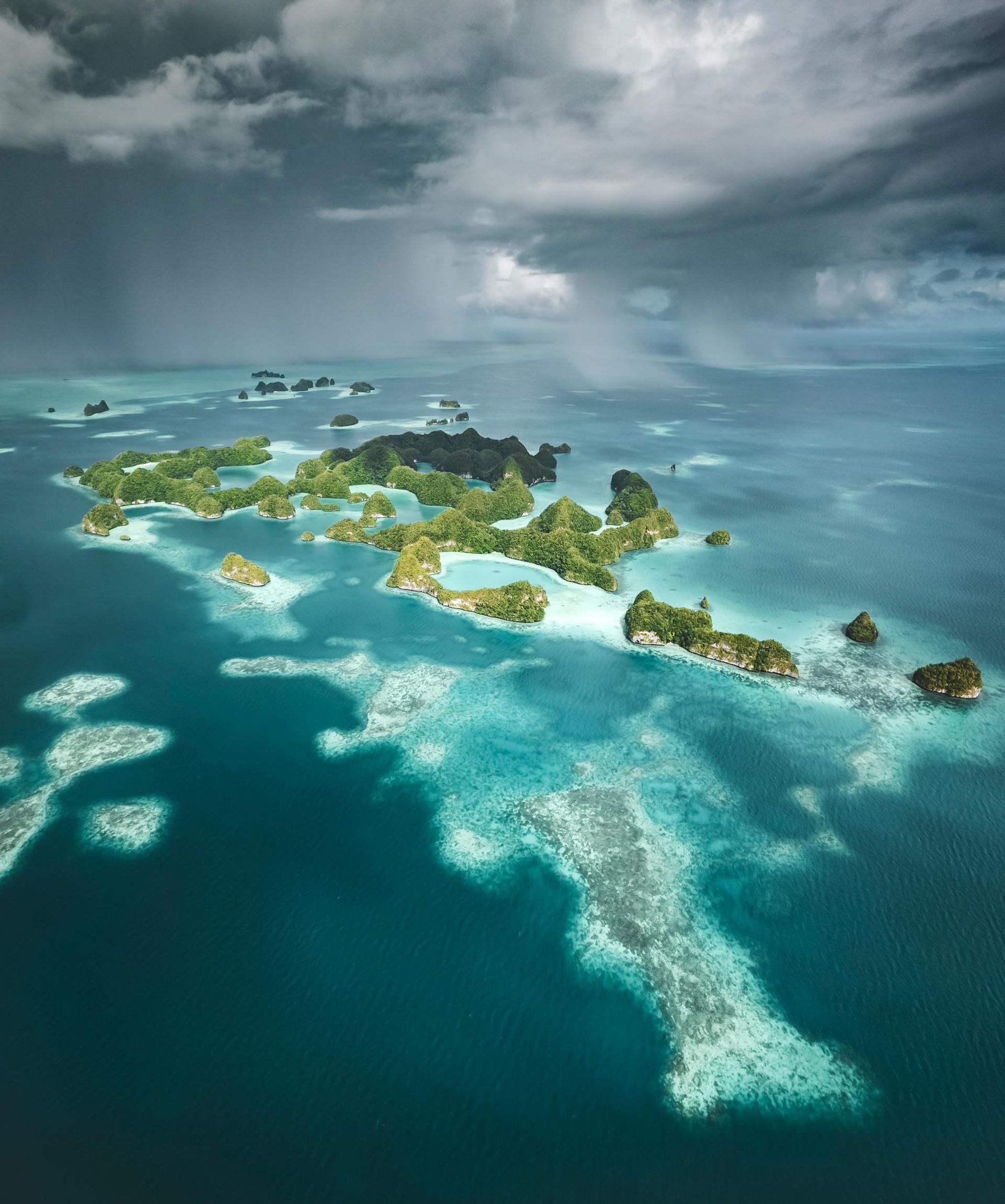 Island archipelago in turquoise waters under a cloudy sky.