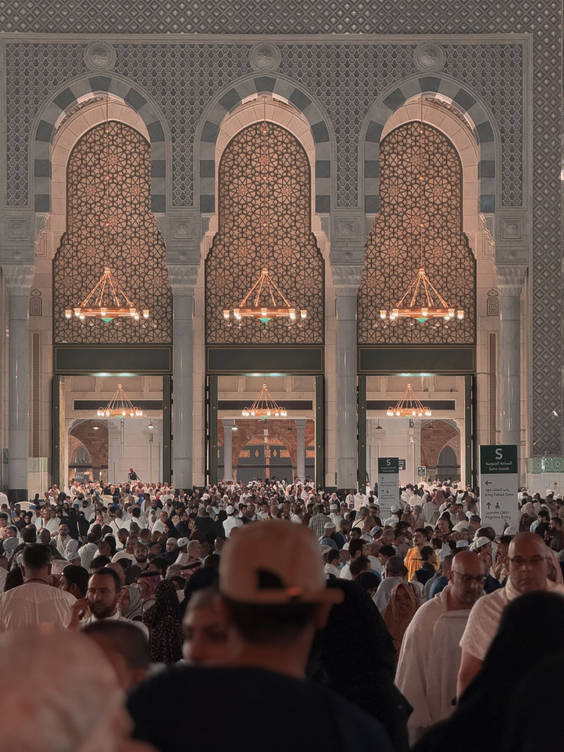 The Kaaba at the center of Mecca’s Grand Mosque, surrounded by crowds of pilgrims at night.