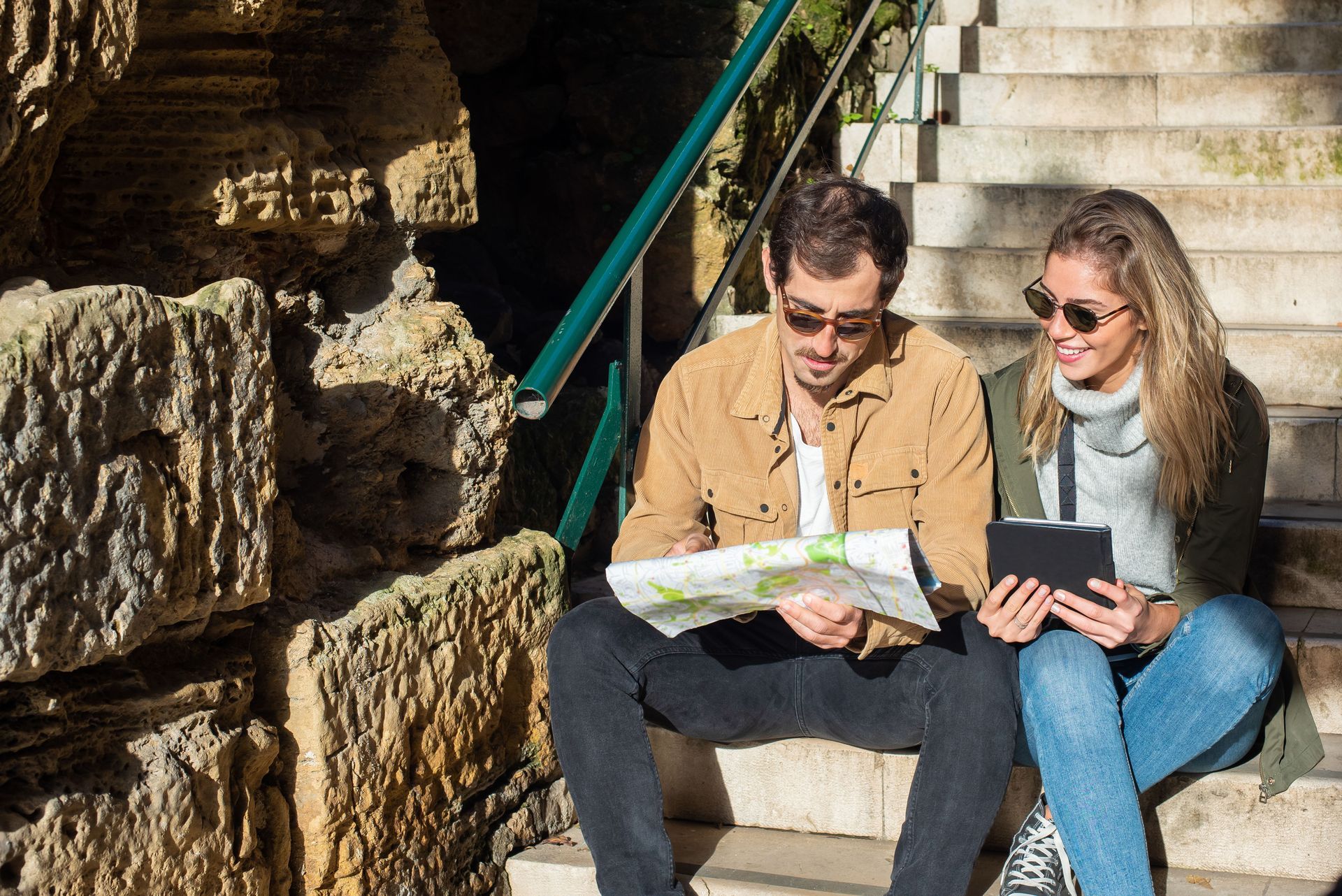 Travellers planning a multi-centre holiday with a map
