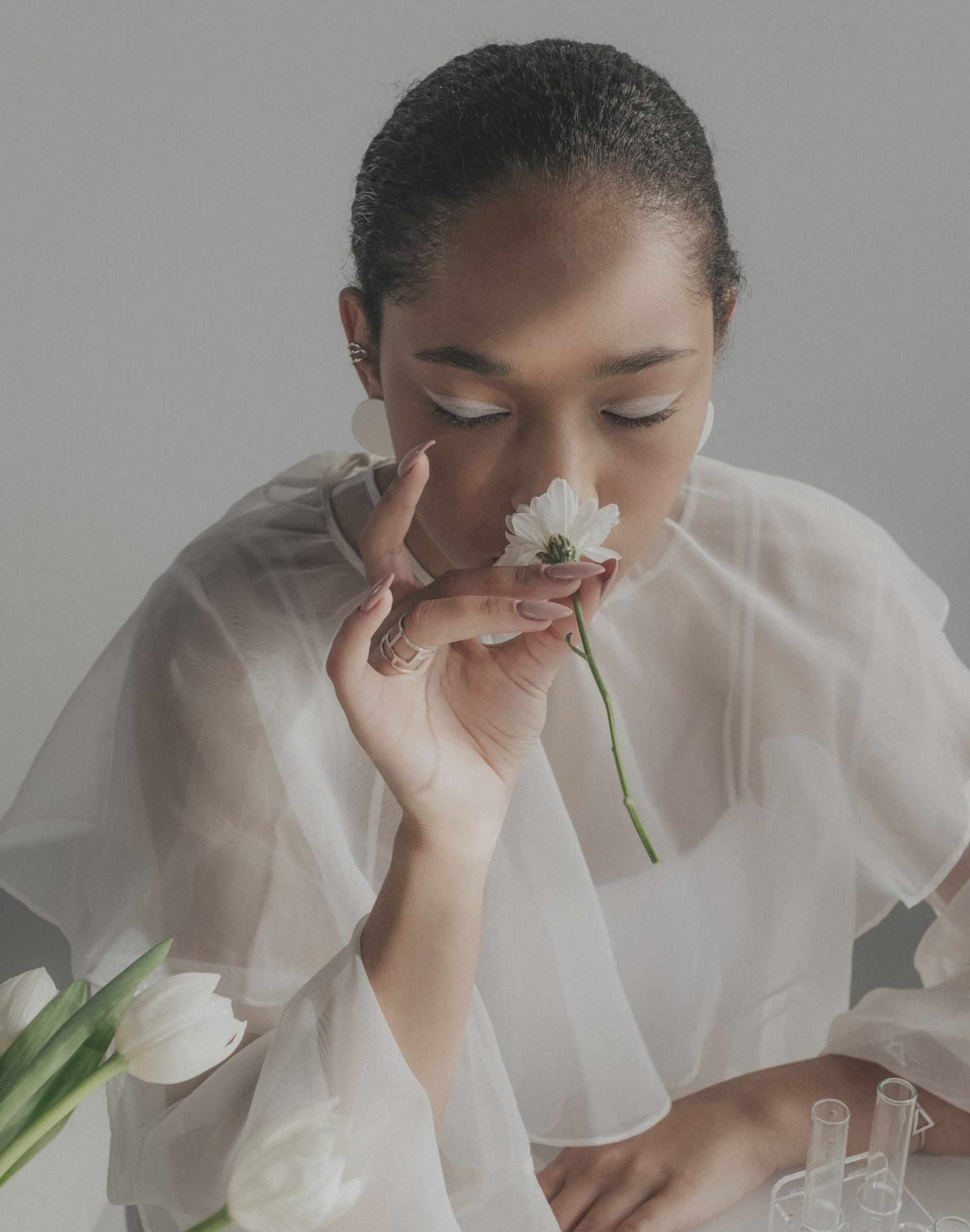 Woman in wedding dress wearing ring and earrings