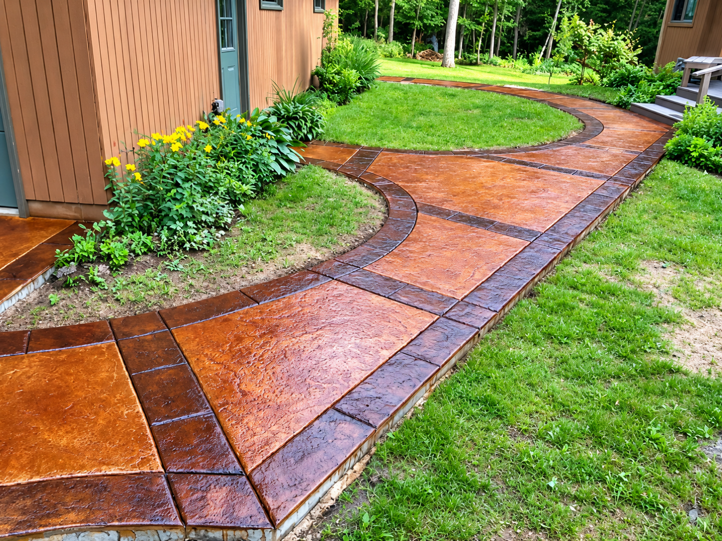 Stamped concrete walkway curves through landscaped yard after Concrete Services in Minnetonka, MN for decorative access.