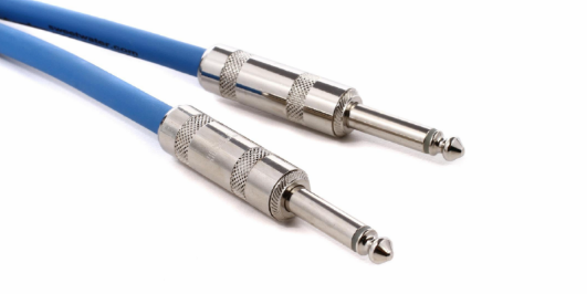 A close up of a pair of guitar cables on a white background.