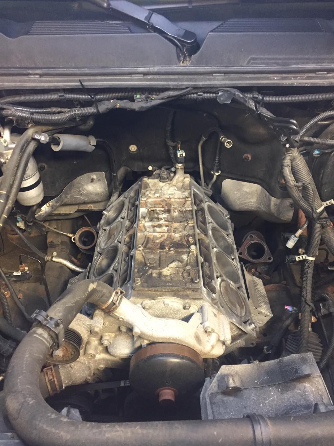 A close up of a car engine with the hood open.