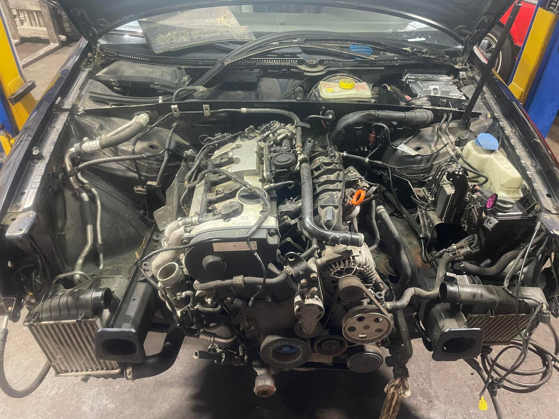 The engine of a car is being removed from the car.