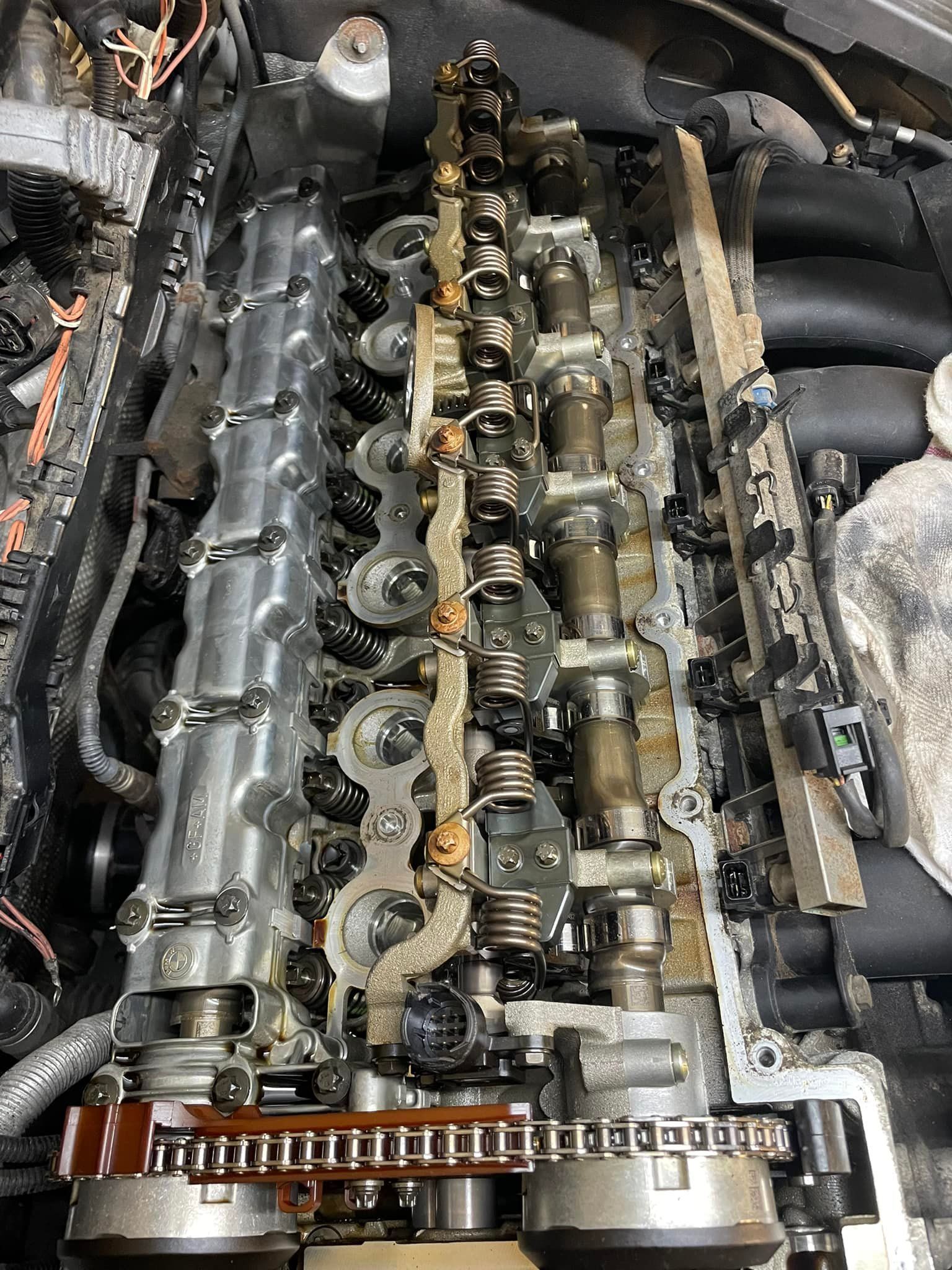 A close up of a car engine with the head removed.