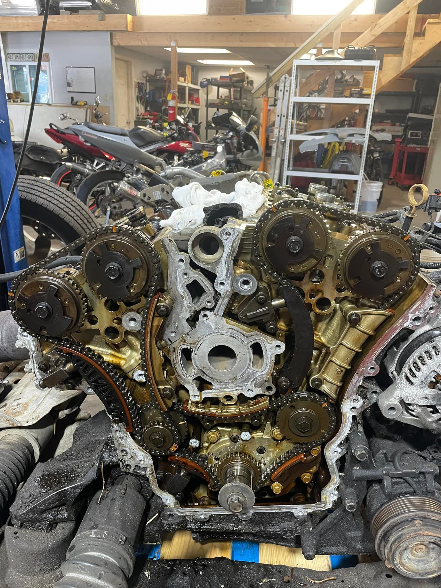 A motorcycle engine is being worked on in a garage.