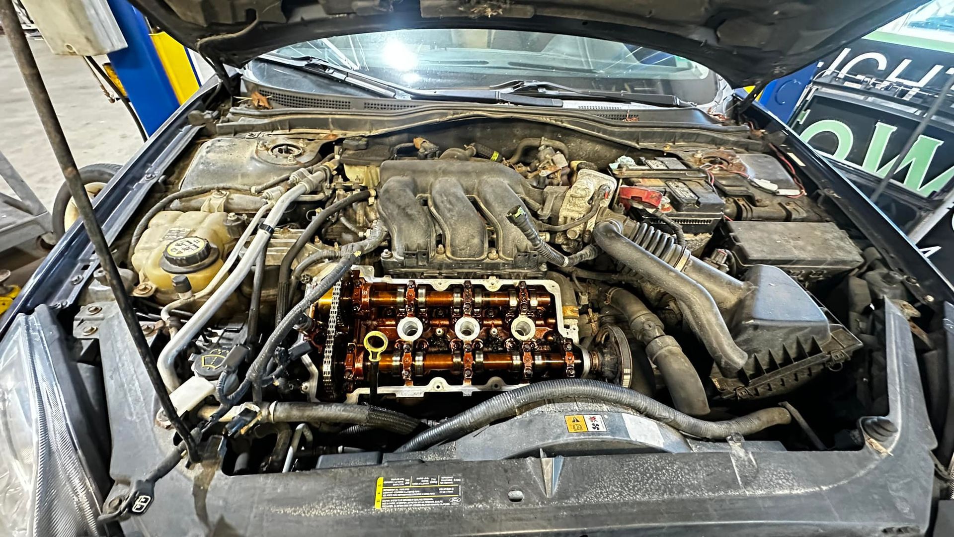 The engine of a car is shown with the hood open.