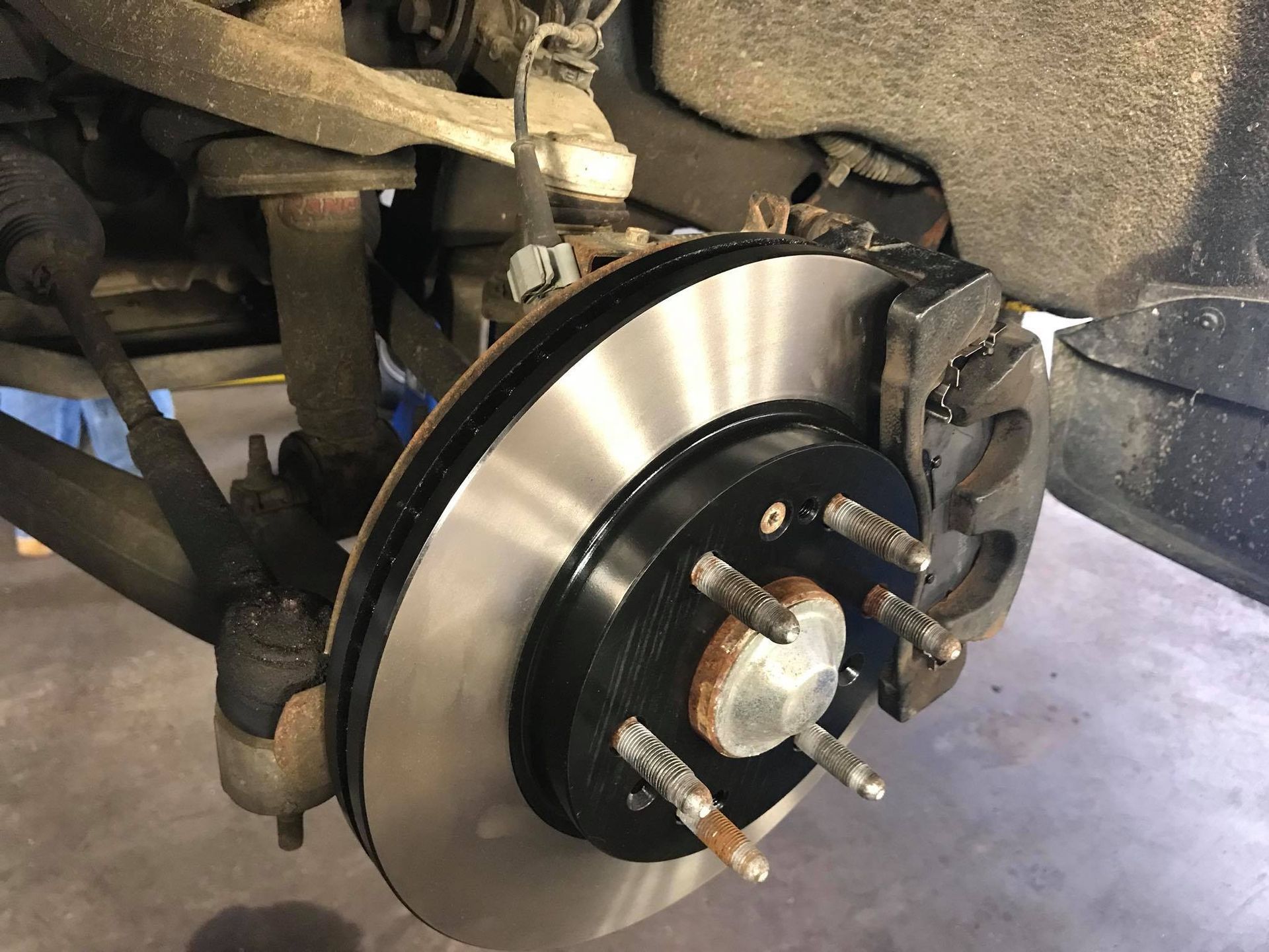 A close up of a brake disc on a car.