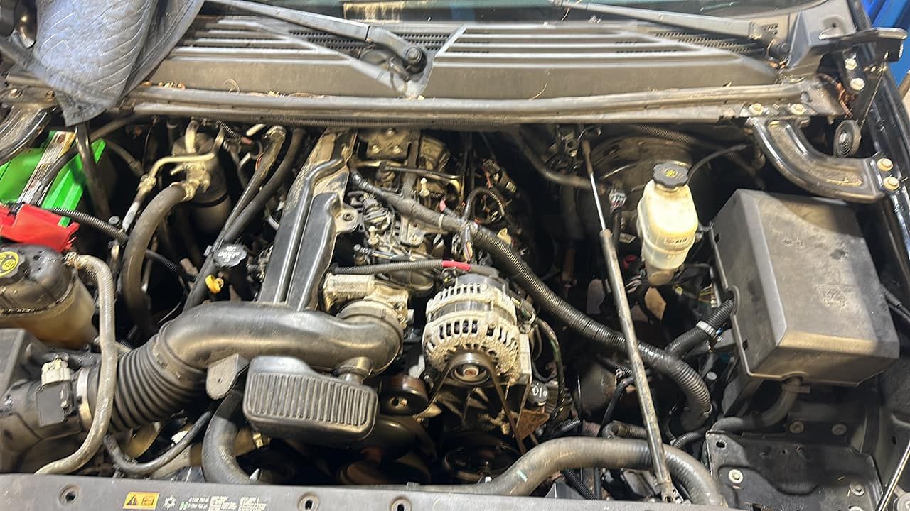 The engine of a car is shown with the hood open.