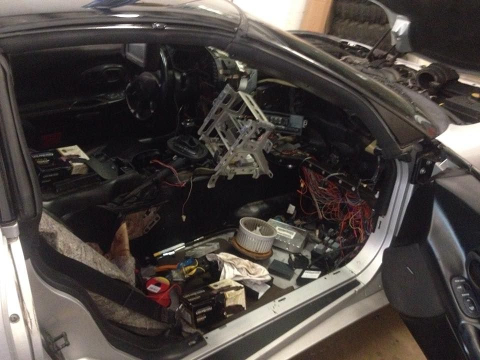The inside of a car with a lot of wires coming out of it