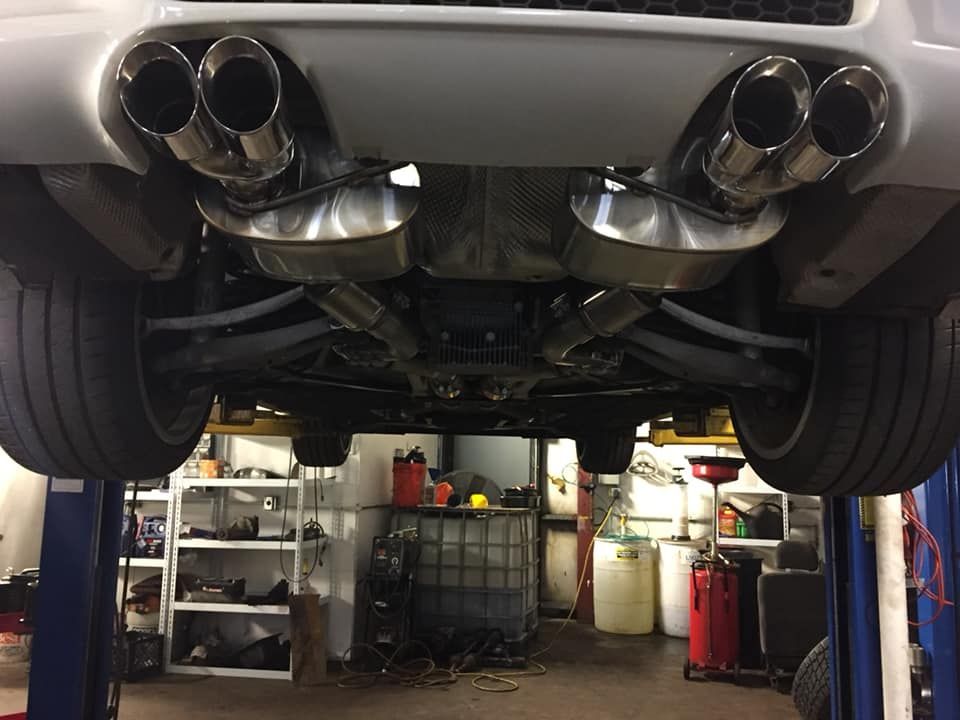 A car is sitting on a lift in a garage
