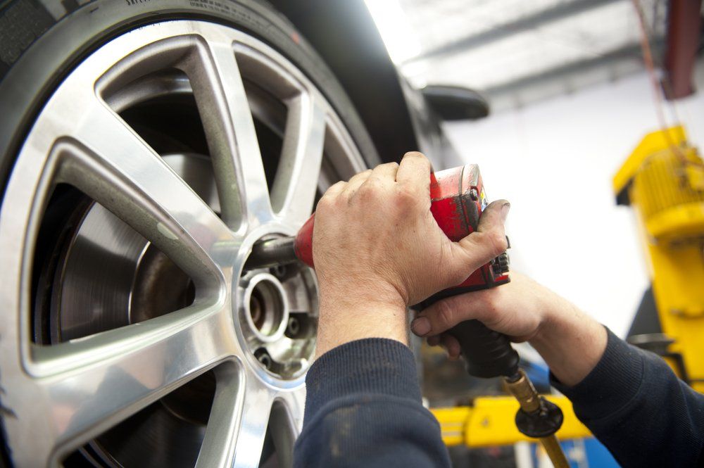 Mechanic Removing Tire — Richmond Valley Tyres in Casino