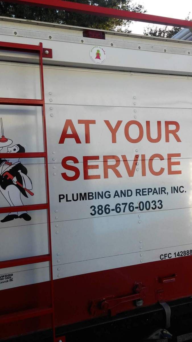 White plumbing truck with red lettering: