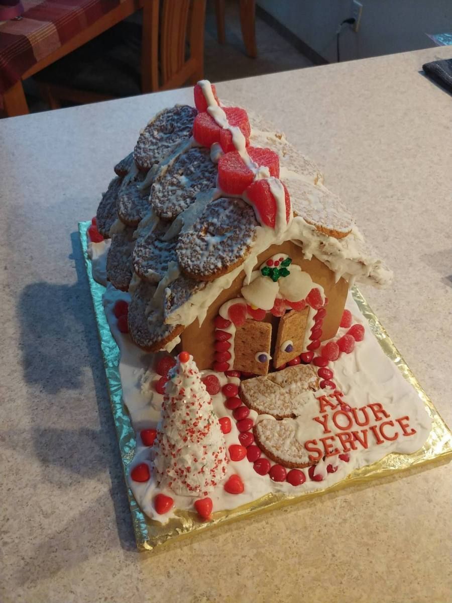 Gingerbread house decorated with cookies, candies, and