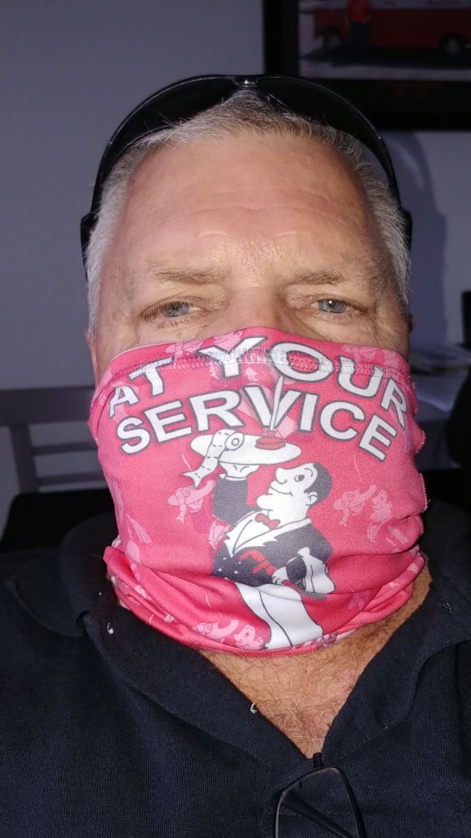 Man wearing a pink face covering with