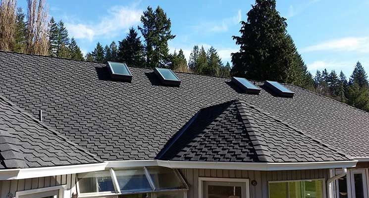 A house with a roof that has three skylights on it  taken  by local roofer, Riverside Roofing in Marysville WA