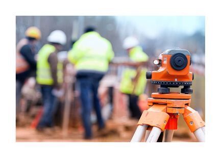 Land surveyors measuring in the background