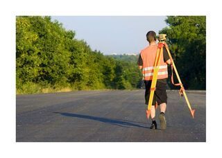 Construction survey worker on road