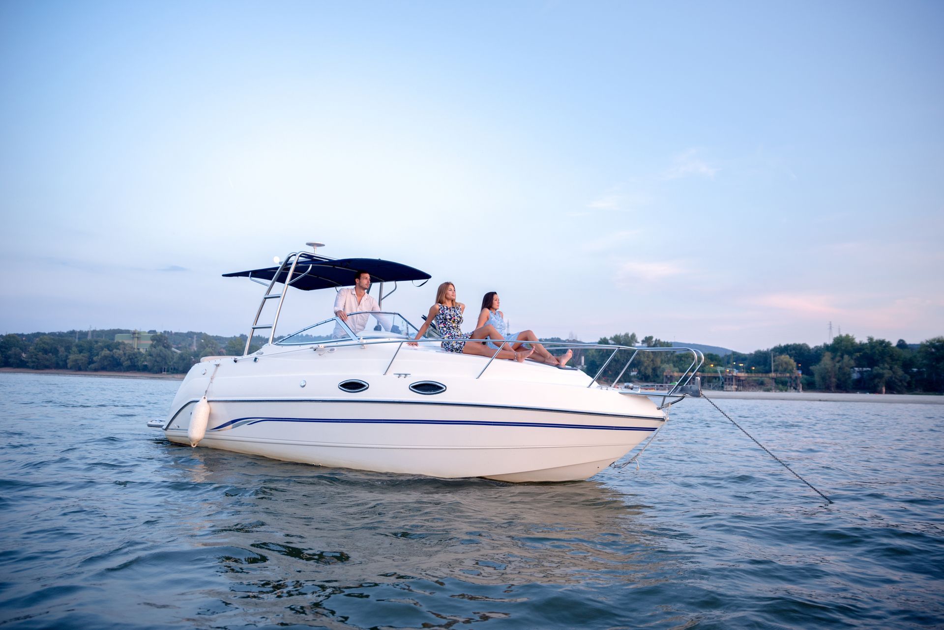 Friends on a boat are enjoying the sunset. Friends on a boat are enjoying the sunset.