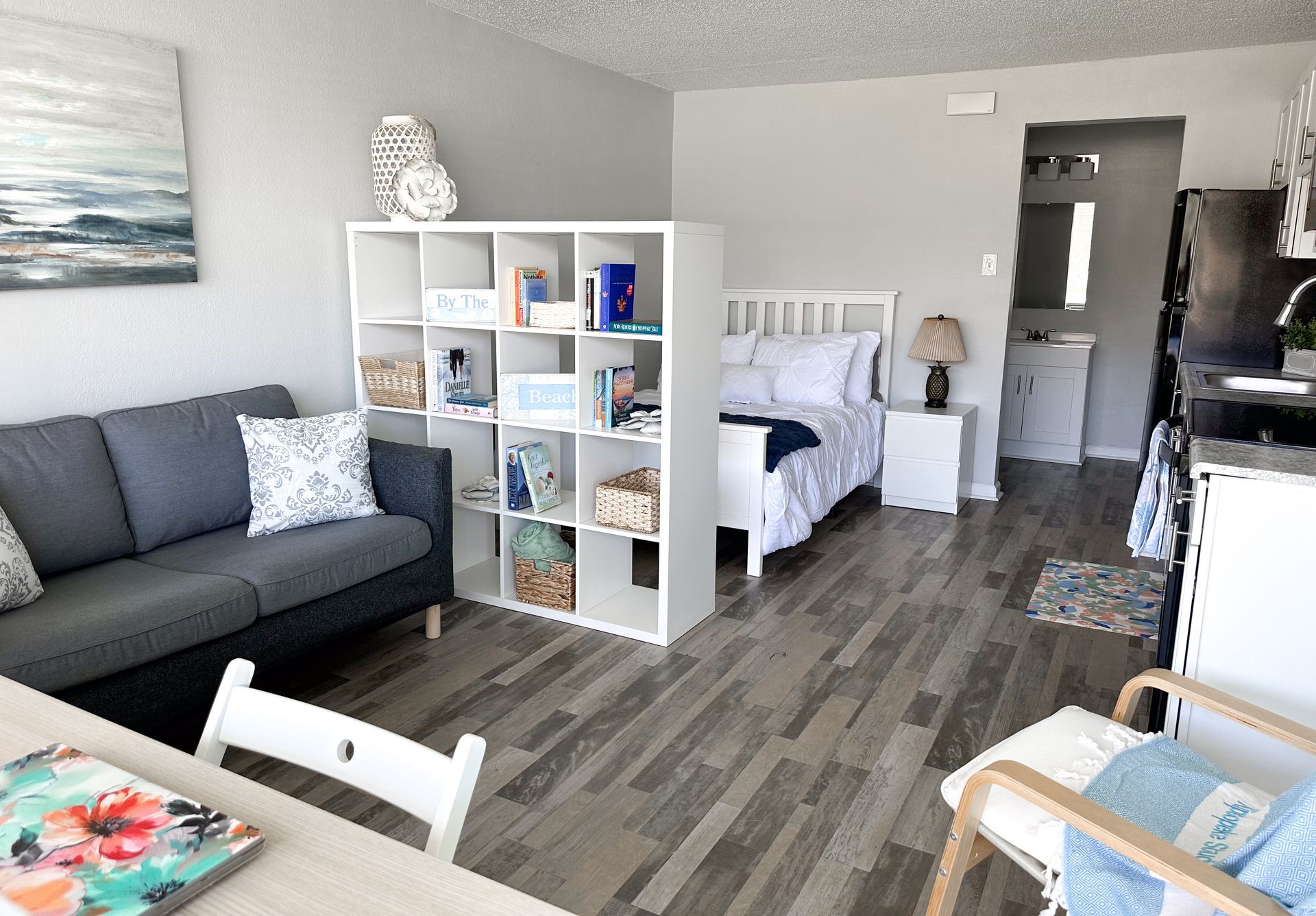 A living room with a couch , table , chairs and a bed.