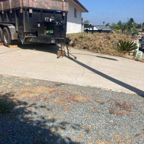 Dump truck parked on a driveway beside a house