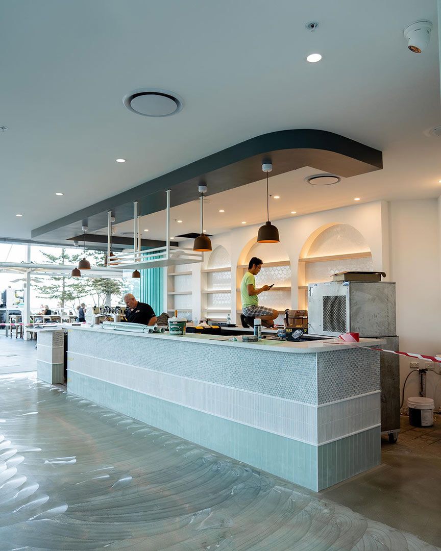 A Man is Standing Behind a Counter in a Restaurant — JIC Projects Pty Ltd in Runaway Bay, QLD