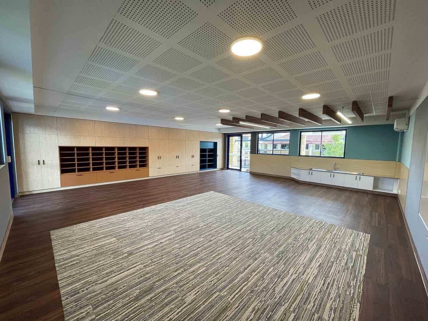 A Large Empty Room With a Rug on the Floor and a Ceiling — JIC Projects Pty Ltd in Runaway Bay, QLD