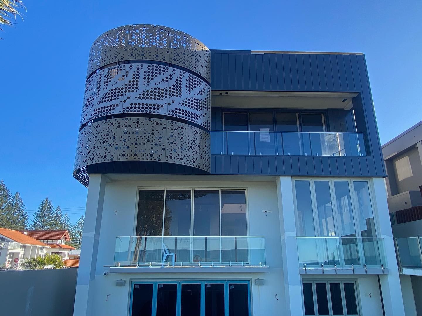 A Large Building With a Balcony and a Blue Sky in the Background — JIC Projects Pty Ltd in Runaway Bay, QLD