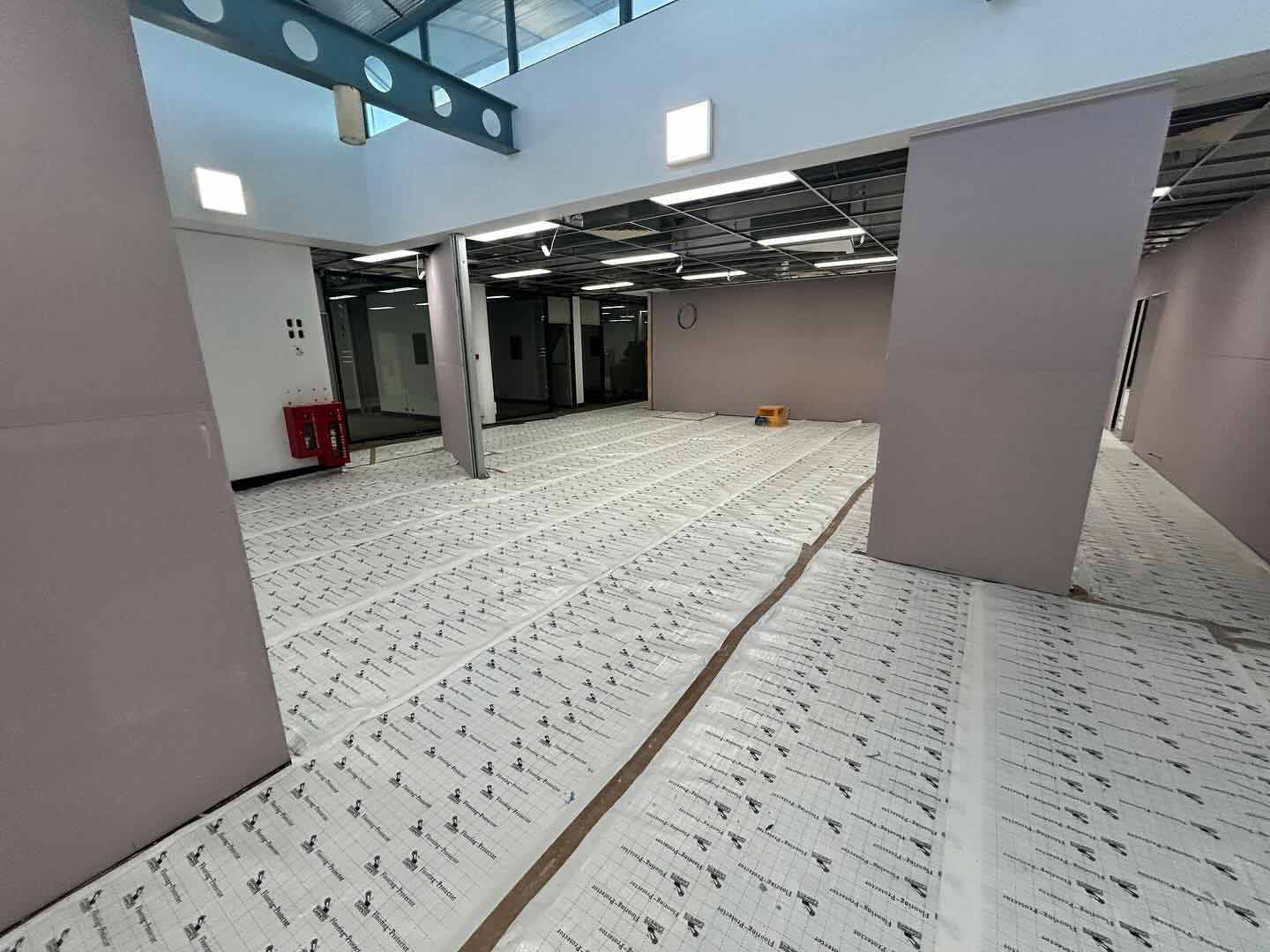 A Large Empty Room With a Lot of White Paper on the Floor — JIC Projects Pty Ltd in Runaway Bay, QLD