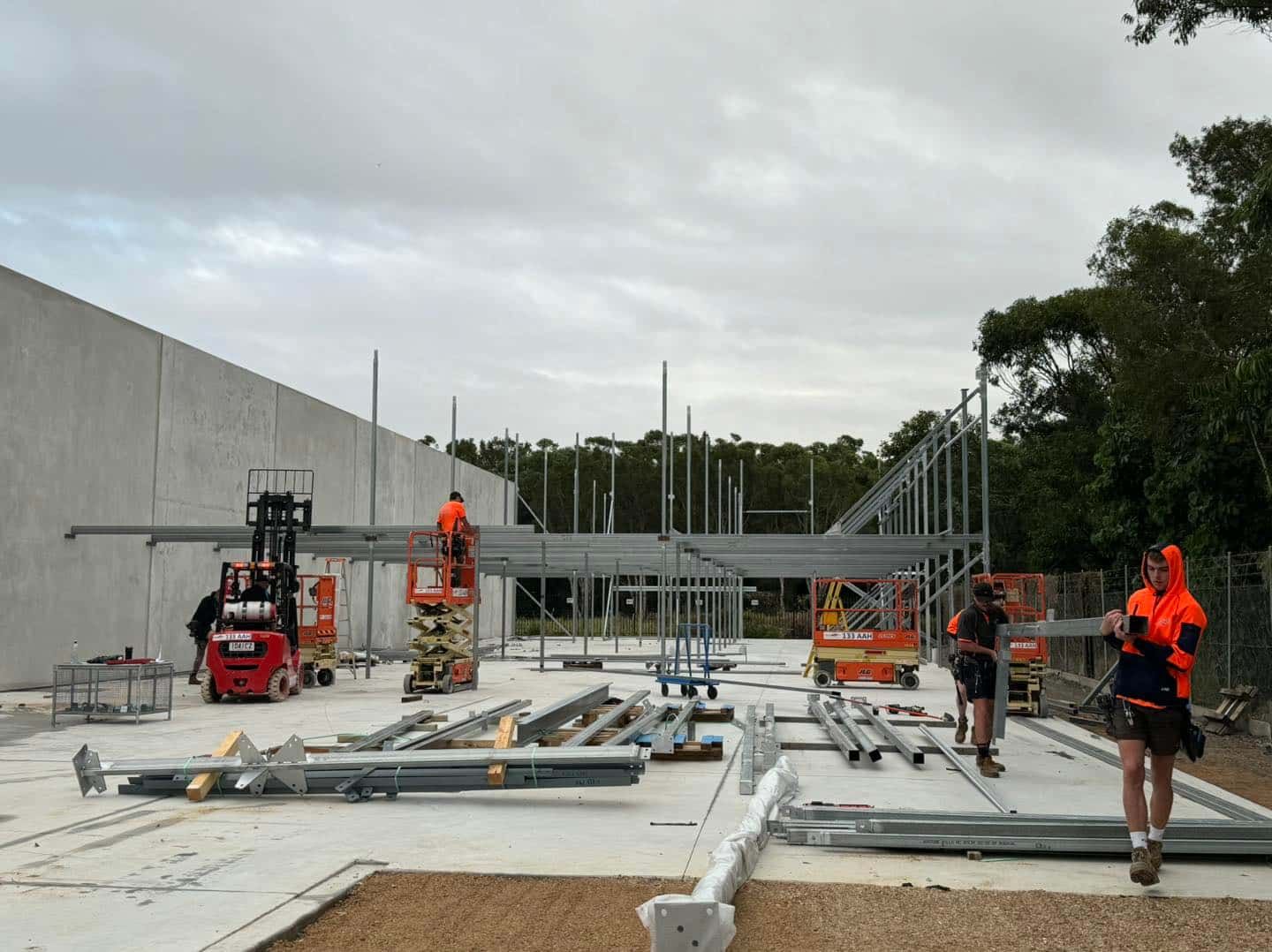 A Group of Construction Workers Are Working on a Building — JIC Projects Pty Ltd in Byron Bay, QLD