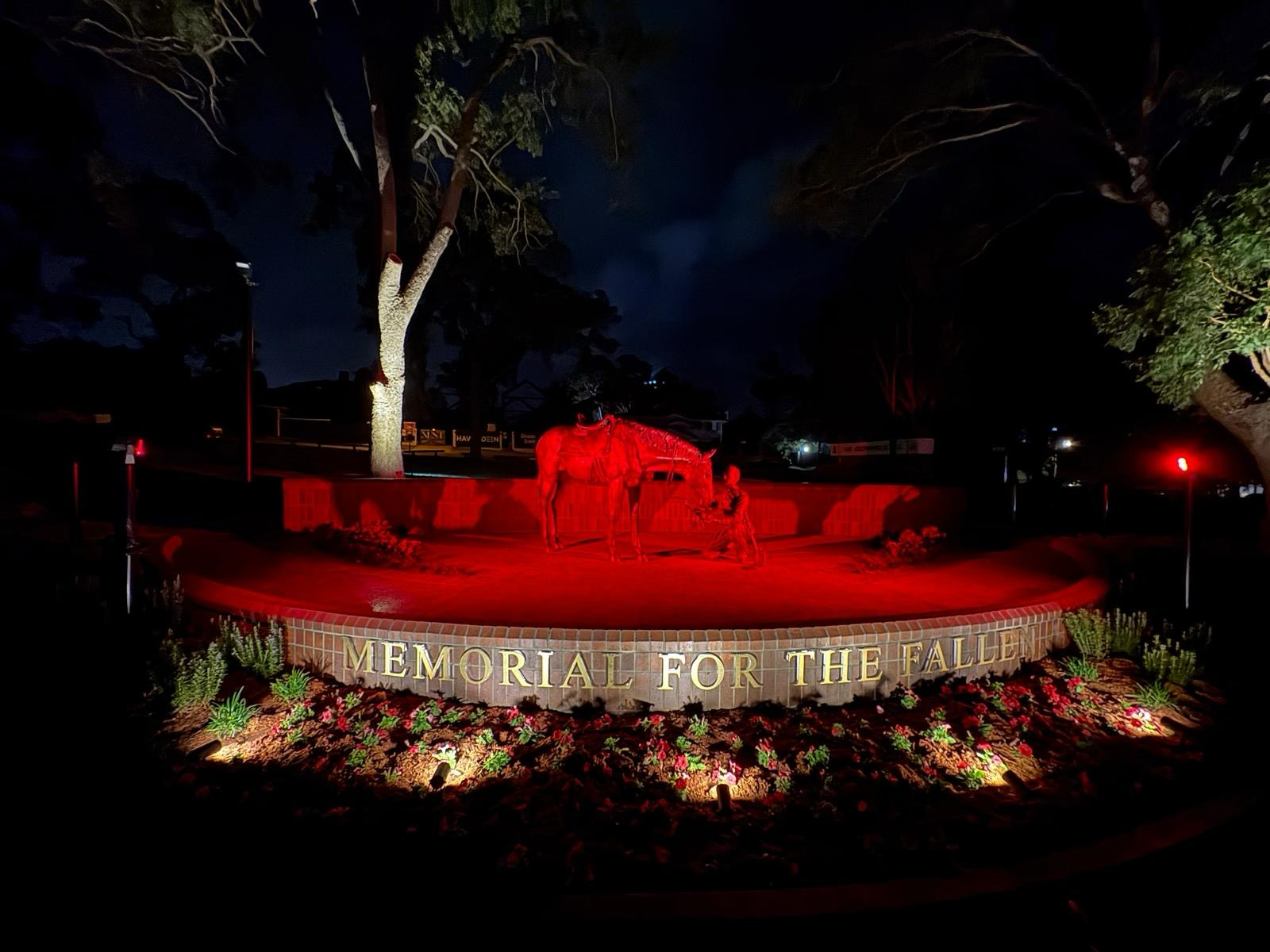 A War Memorial Illuminated in Red Light at Night  — JIC Projects Pty Ltd in Runaway Bay, QLD