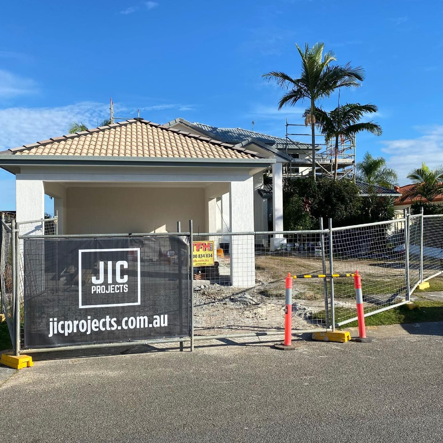 A New Home Being Built With Builders Fencing And JIC Projects Banner — JIC Projects Pty Ltd in Runaway Bay, QLD