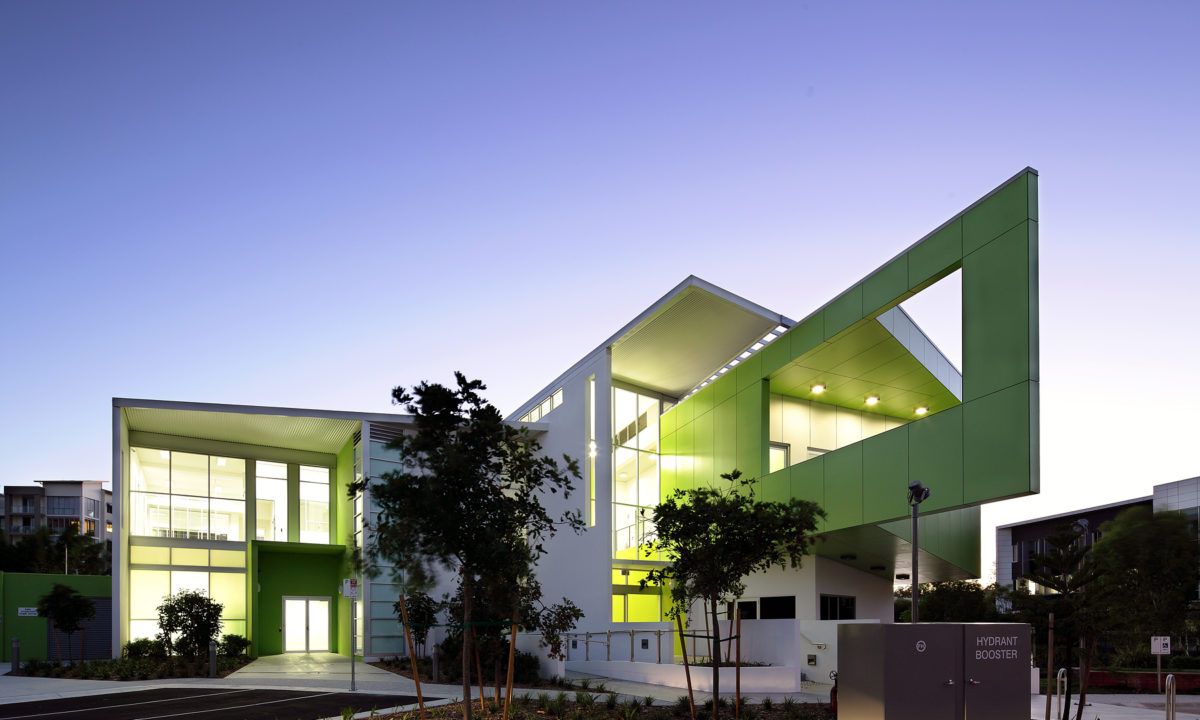 Modern Green Building With Angular Architecture Set Against a Twilight Sky — JIC Projects Pty Ltd in Runaway Bay, QLD