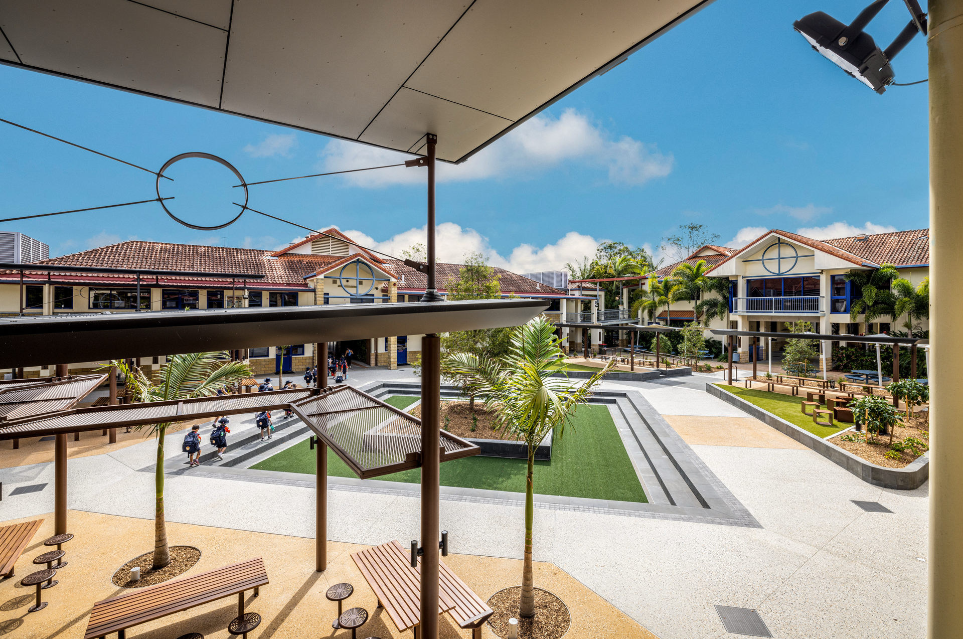 An Outdoor School Courtyard with Green Grass, Palm Trees — JIC Projects Pty Ltd in Runaway Bay, QLD