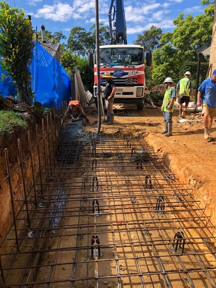 A Group of Construction Workers Are Working on a Construction Site — JIC Projects Pty Ltd in Runaway Bay, QLD