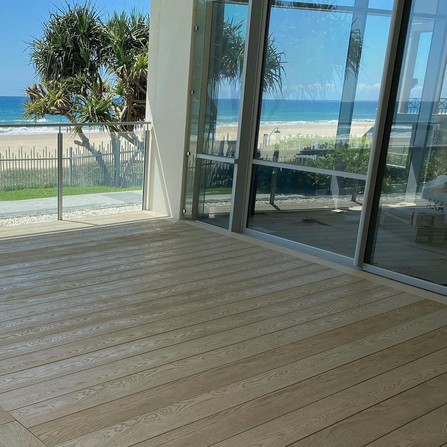 An Open Deck With Beach View and Glass Large Windows — JIC Projects Pty Ltd in Runaway Bay, QLD