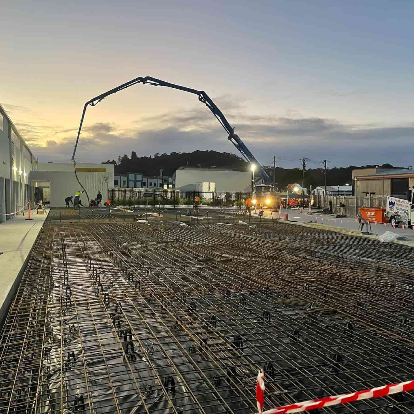 A Concrete Pump is Being Used to Pour Concrete on a Construction Site — JIC Projects Pty Ltd in Runaway Bay, QLD