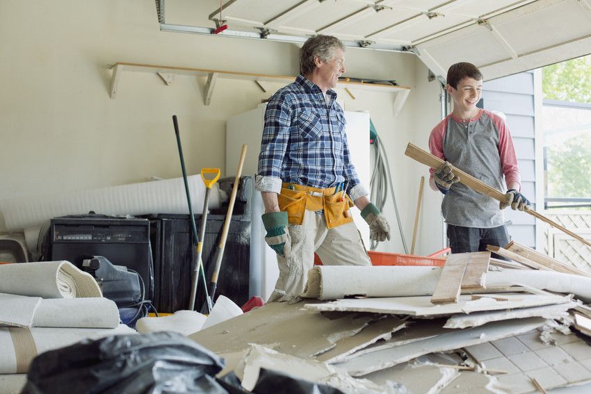 2 people stood looking at a pile of waste