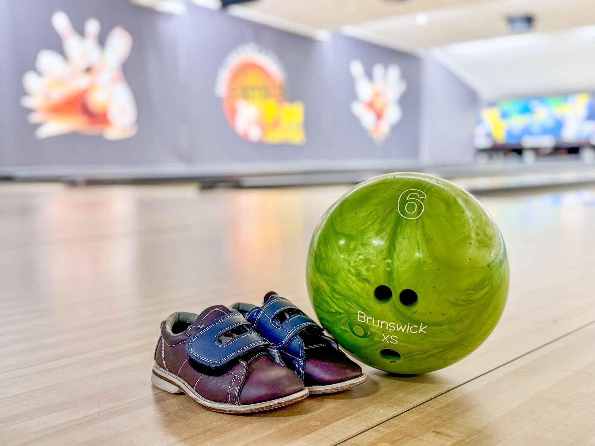 Person holding a bright pink bowling ball with the number 7 against a dark background