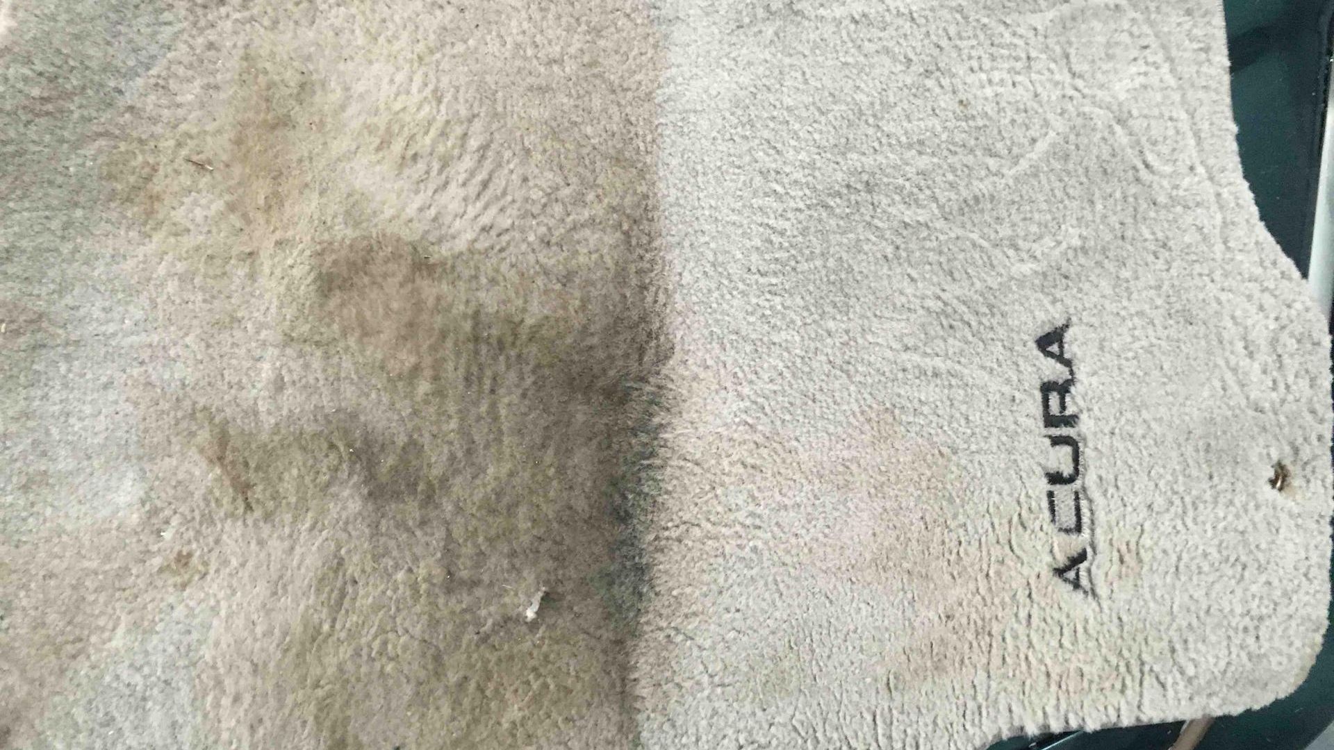A close up of a carpet with the word acura embroidered on it.